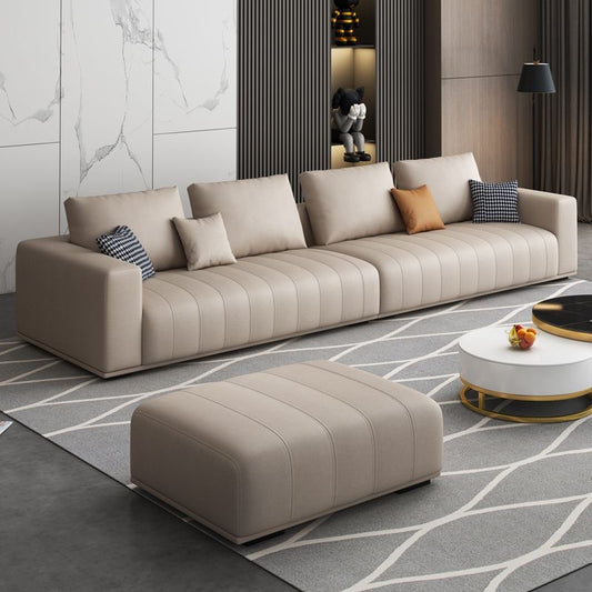 Beige leather 4 seater sofa with loose leather ottoman