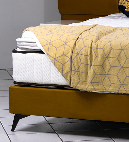 Headboard and base set upholstered in beautiful mustard fabric, this bed has black steel legs and an extra width headboard