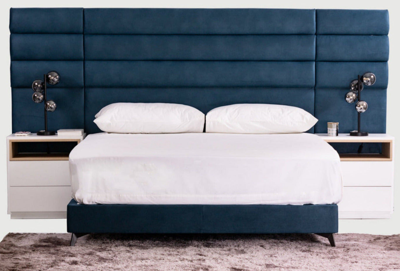 The Jones sleigh bed has an extra width headboard with adjustable height. Get the headboard and base set or the whole bedroom set including mattress, topper and pedestals.