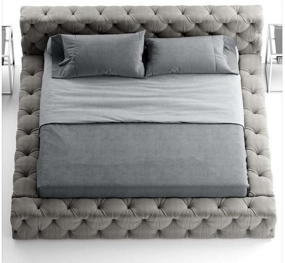 deep button sleigh bed. This headboard and base set has a deep button design all around.