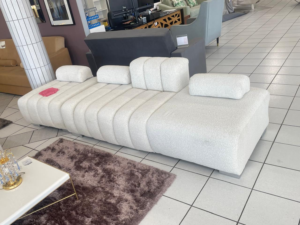 La vie daybed ottoman sofa with backrest and armrests and loose ottoman on the left.