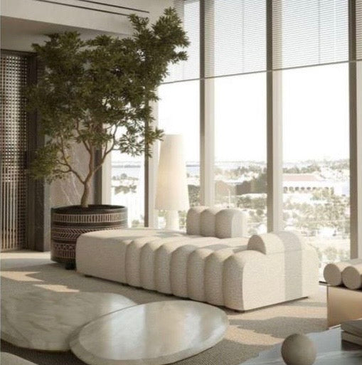 Daybed sofa with channel design, upholstered in fabric.