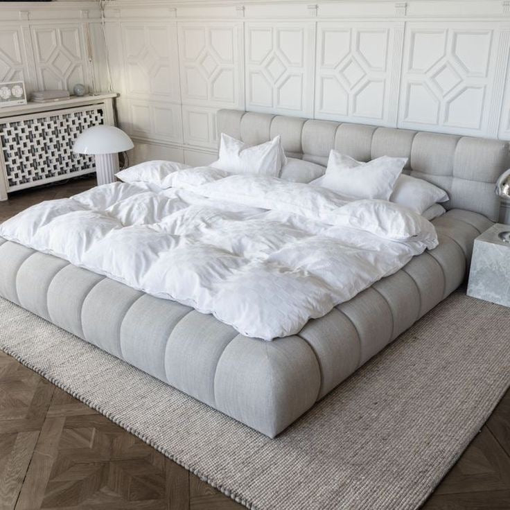upholstered sleigh bed in light grey fabric
