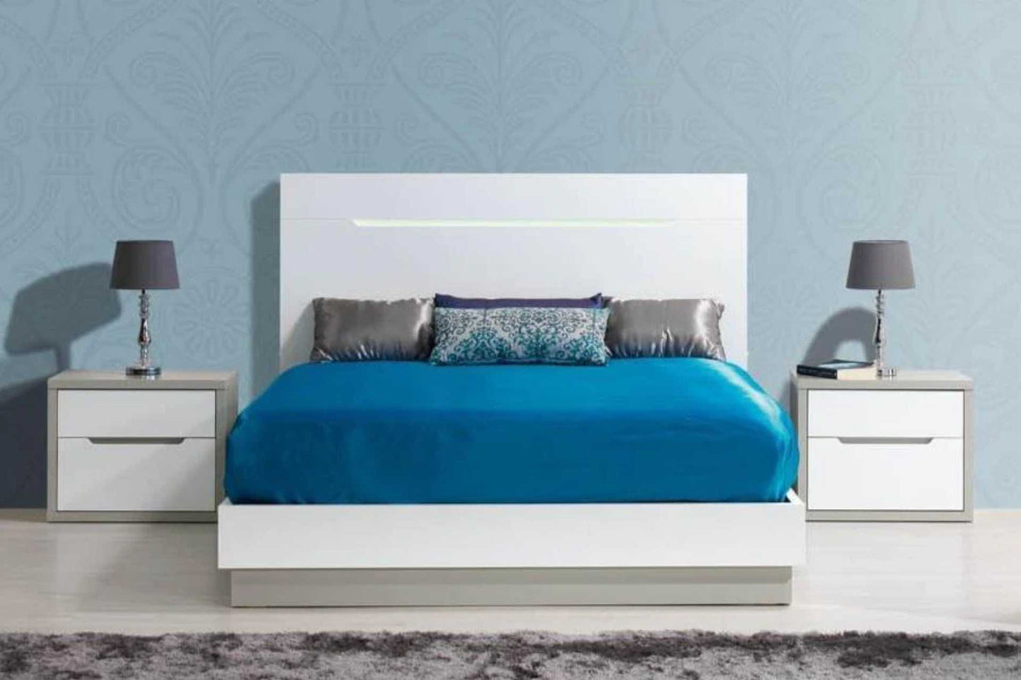 white wood sleigh bed with two matching pedestals and LED lighting feature on headboard