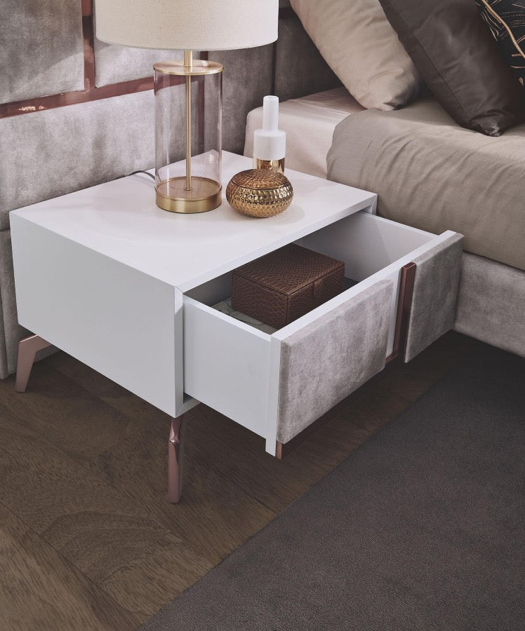 White wood pedestals with grey velvet fabric and rose gold metallic strips and feet.