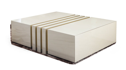 Vector coffee table in a gloss ivory wood, has two hidden drawers and a cut out ridges design. handmade in Europe, this luxury coffee table adds a touch of elegance to your living room.