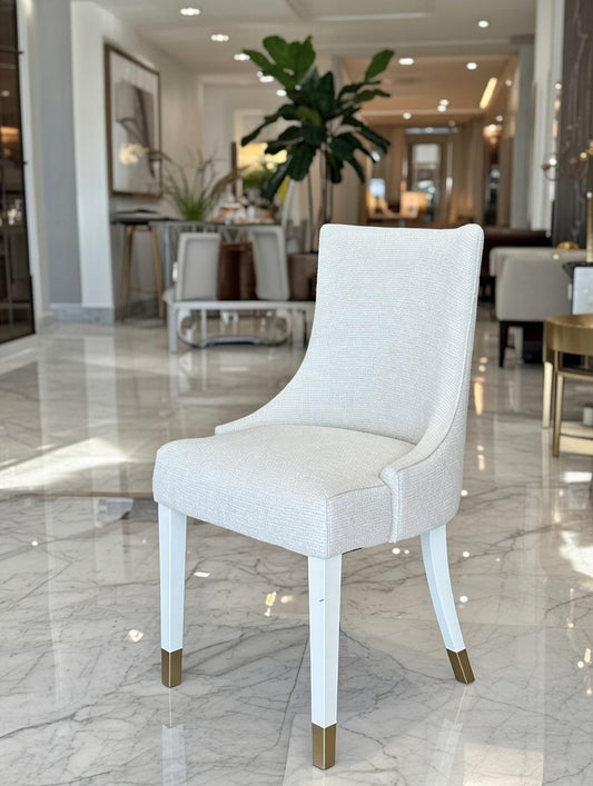 Luxury dining chair in ivory fabric with white legs and gold tips