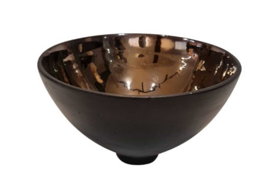 Black ceramic bowl with gold interior