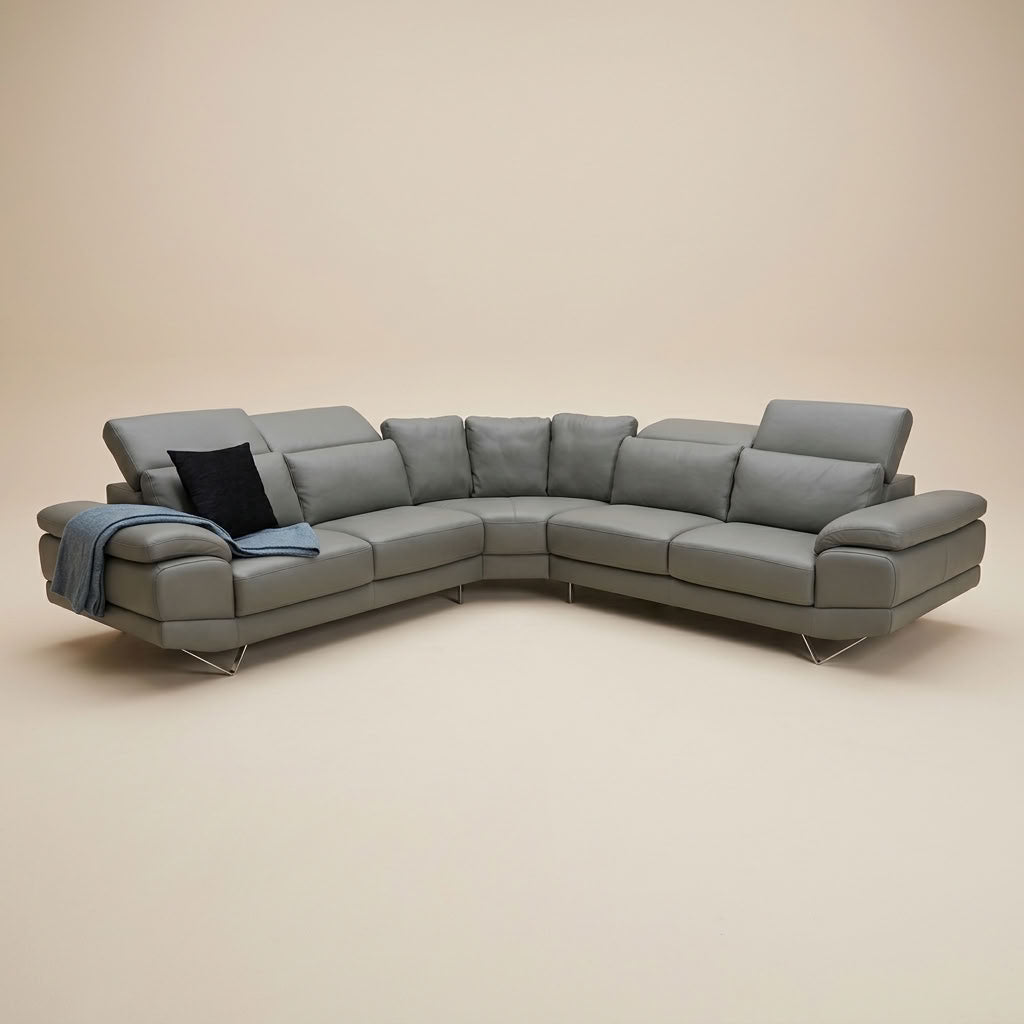 Mid grey leather corner couch with adjustable headrests and chrome feet. GALERIA FURNITURE SOUTH AFRICA.