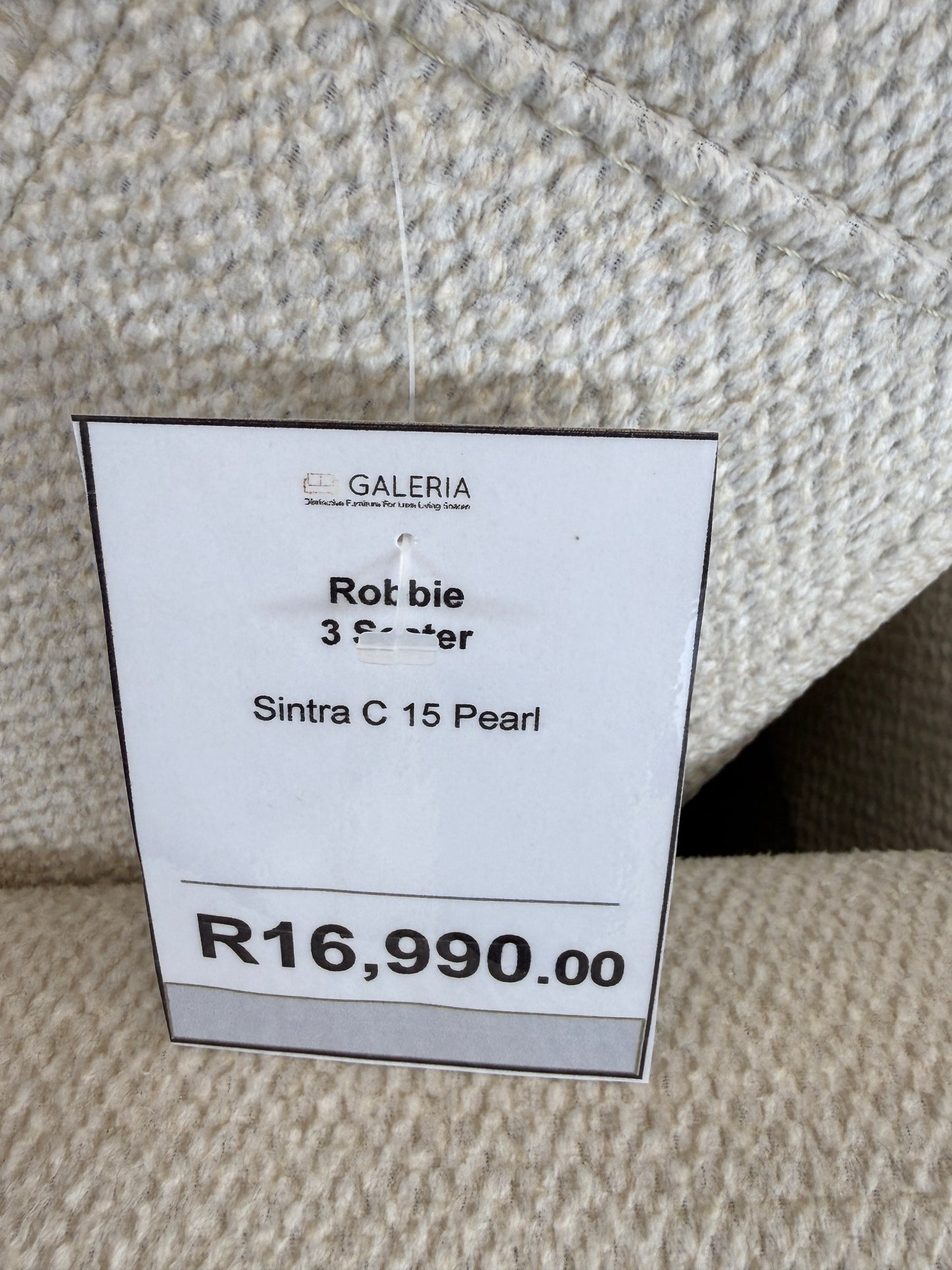 Close-up of soft feel textured light beige fabric for the Robbie Sofa. GALERIA FURNITURE SA.