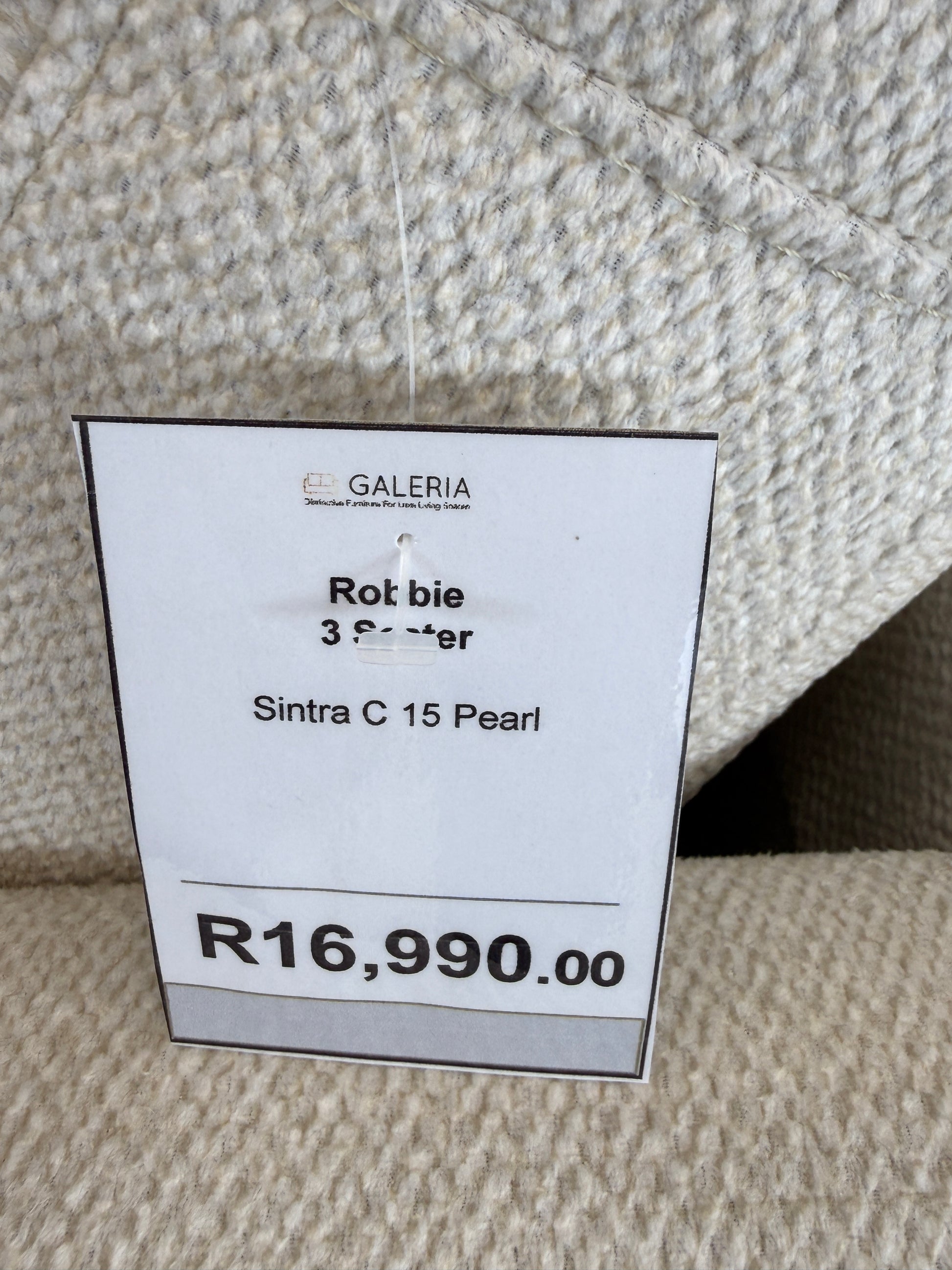 Close-up of soft feel textured light beige fabric for the Robbie Sofa. GALERIA FURNITURE SA.