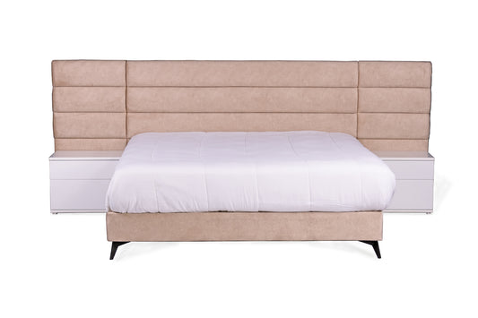 Upholstered sleigh bed in beige velvet. White wood pedestals are included in price.