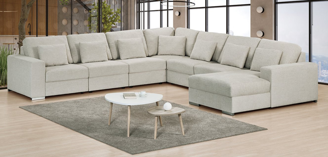 Large corner couch with a movable ottoman in luxury easy clean cream fabric.