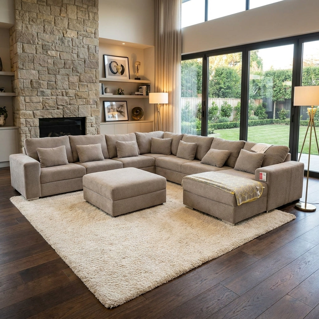 A 8 seater designer couch in luxury Taupe fabric. The sofa has a movable ottoman and a daybed. Handmade in Europe and available exclusively at Galeria Furniture South Africa