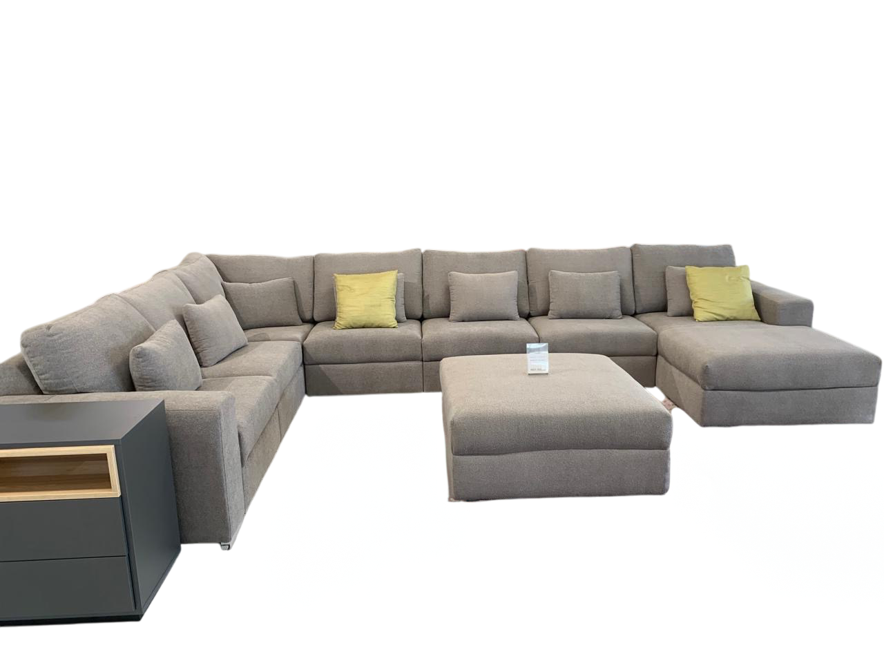 Large corner couch in grey fabric with loose ottoman