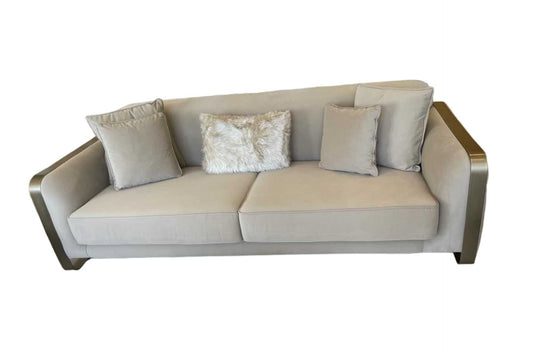 Beige velvet 3 seater sofa with gold brass arms and feet.