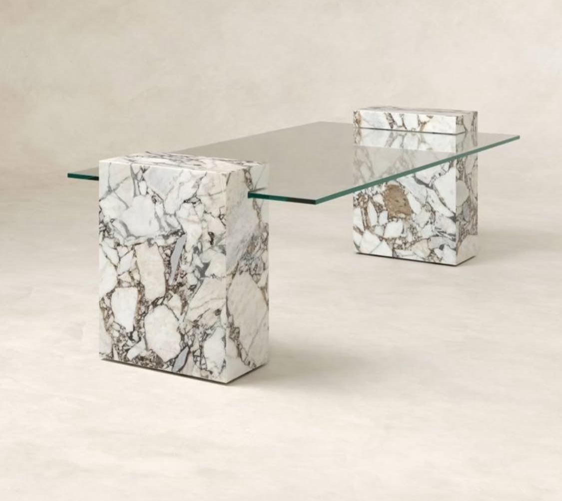Glass-top dining table with stone pillar legs, customisable in size and stone colour.