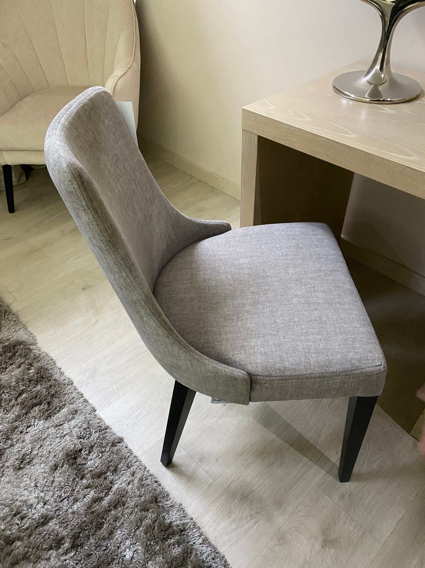 grey fabric dining chair with black wooden legs. European design, exclusive to Galeria Furniture in Mbombela.