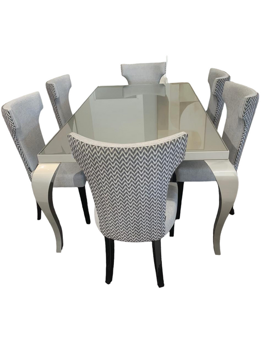 The UNIQUE dining table is a 6-8 seater table with curved vintage style legs, grey gloss wood and glass-top finish.