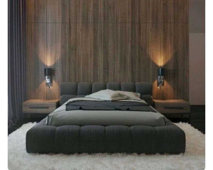 Tufted sleigh bed in charcoal fabric.