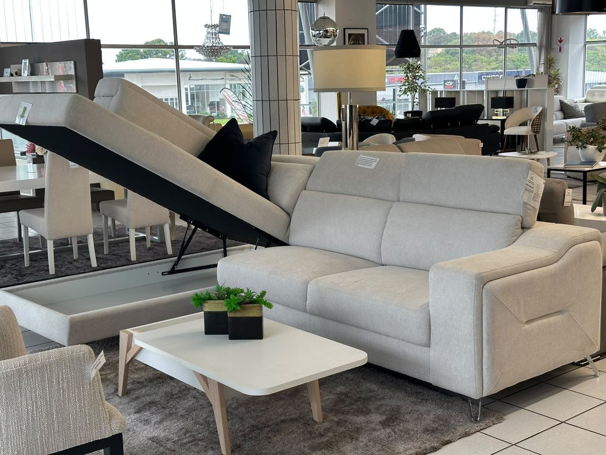 Light grey corner couch with a storage trunk under the daybed. GALERIA FURNITURE SA