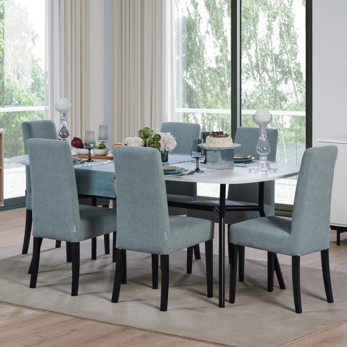 oval top dining table with black steel legs.