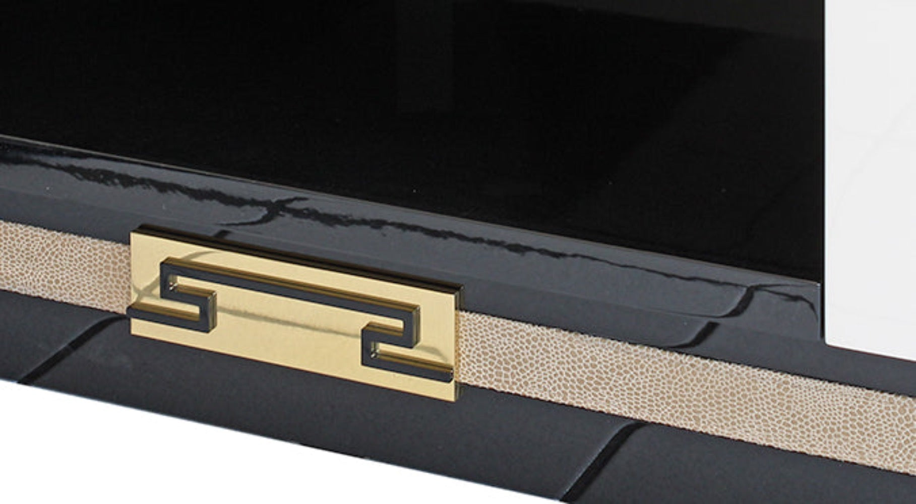 leather strap and gold buckle detail on the tv stand