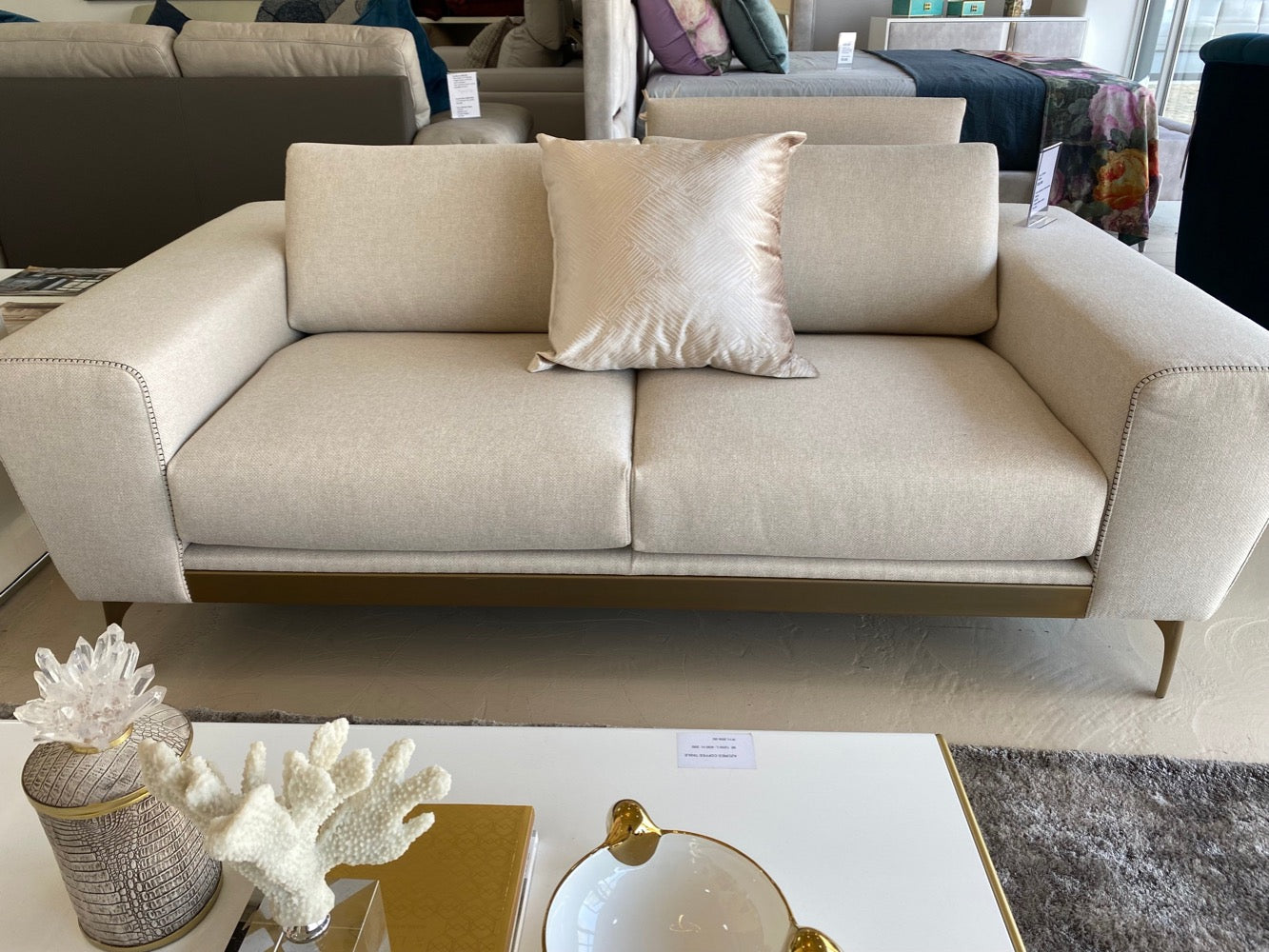 Cream fabric 2 seater sofa with gold feet