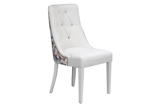 deep button dining chair in white leather and floral fabric back.