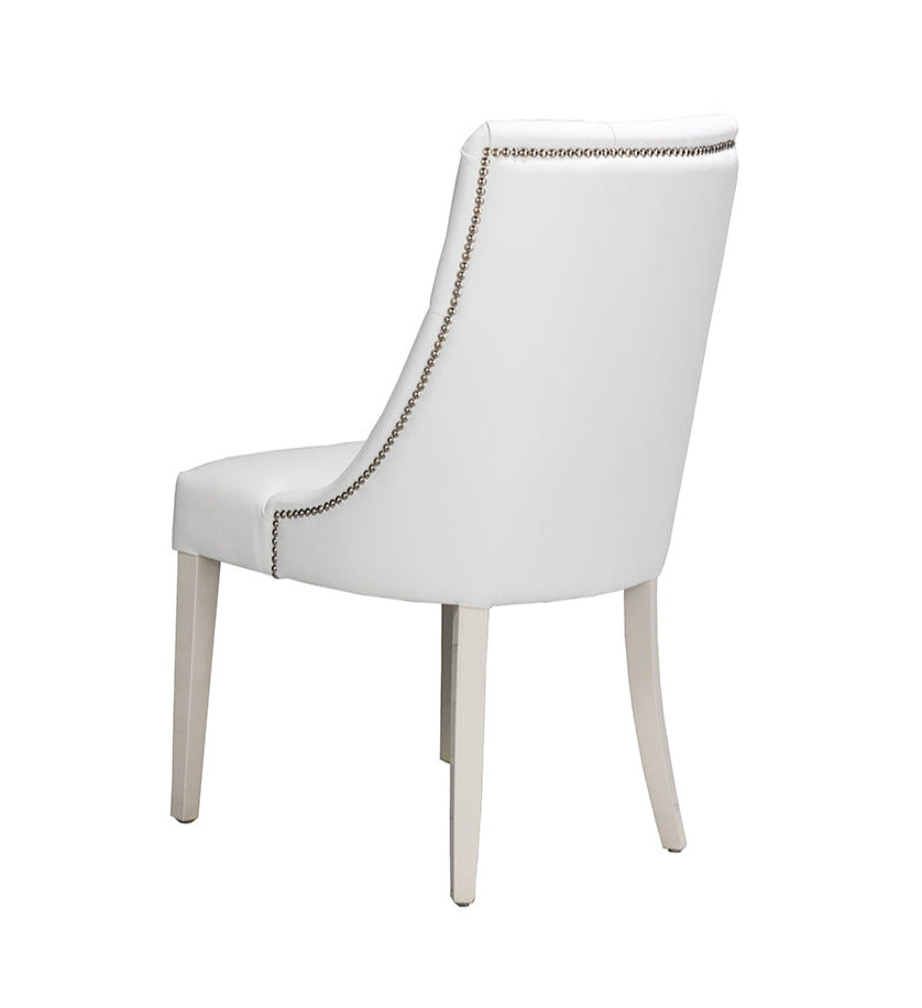 White leather dining chair with silver stud detail and white wooden legs