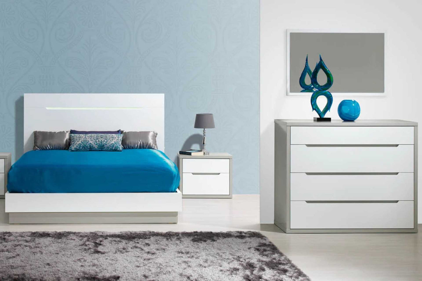 White wood bedroom set includes sleigh bed with 2 matching pedestals in white and grey wood, chest of drawers and bedroom mirror.