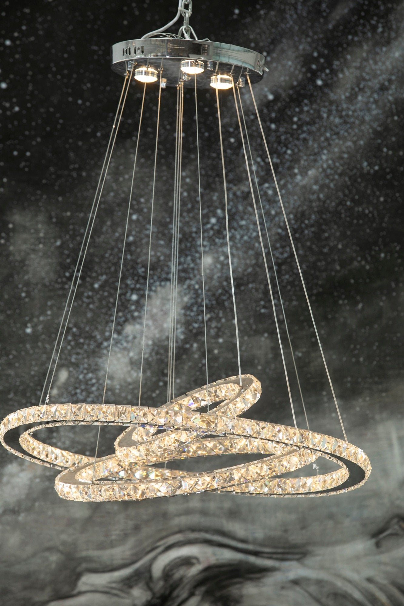 3 ring crystal chandelier with adjustable height and angle.