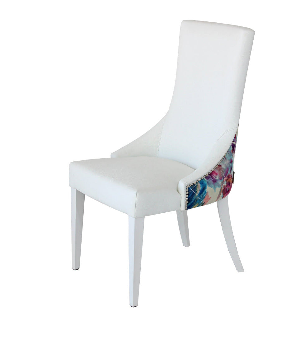 The geneve dinign chair, faux white leather and luxury floral fabric back. 
