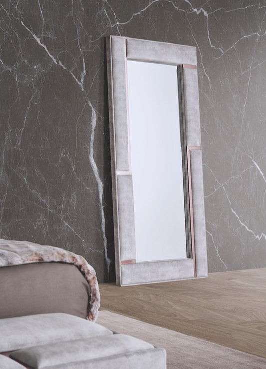 standing bedroom mirror  upholstered in luxe grey velvet with metallic rose gold detail 