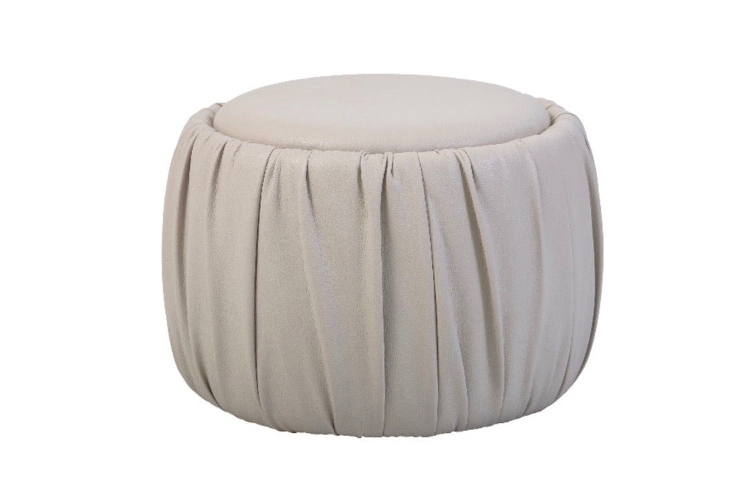 Round Ottoman  in beige faux leather that is very durable