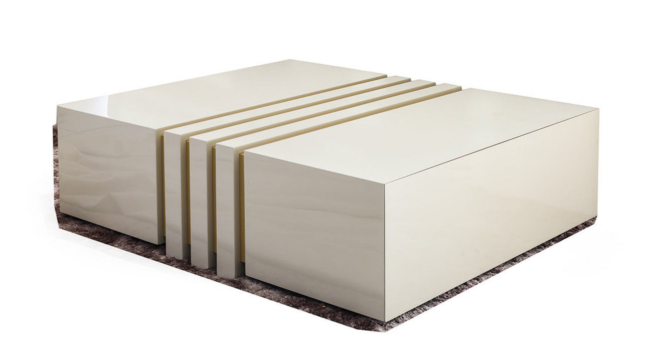 Vector coffee table in a gloss ivory wood, has two hidden drawers and a cut out ridges design. handmade in Europe, this luxury coffee table adds a touch of elegance to your living room. 